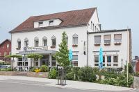 a white building with blue umbrellas in front of it at Bayrischer Hof in Melle