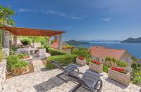 a patio with chairs and a view of the water at Apartments More in Sobra