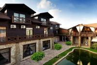 an image of a house with a pond in front of it at Hotel 4x4 in Rivne
