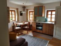 a kitchen with a table and a dining room at Ferienappartement am Leisnitzbach in Tamsweg