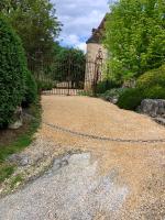 a cobblestone driveway with a fence and a gate at La Maison d&#39;Alice in Vézac