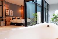 Postel nebo postele na pokoji v ubytování Chill D Resort Buriram