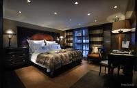 a bedroom with a large bed with a desk and a desk at Hotel Le Saint Roch in Courchevel