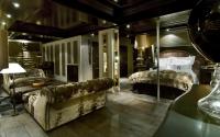 a bedroom with a bed and a couch in a room at Hotel Le Saint Roch in Courchevel