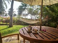 a hammock sitting on a wooden table with a hammock at Taj Holiday Village Resort & Spa, Goa in Candolim