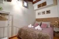 A bed or beds in a room at La Buhardilla de Andrea