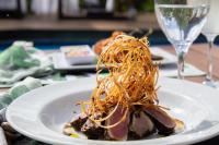 a plate of food with spaghetti on a table at Dolphin Hotel in Fernando de Noronha