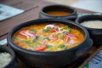 a bowl of soup with vegetables and rice on a table at Dolphin Hotel in Fernando de Noronha