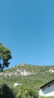 a hill in the distance with a blue sky at Villa Nadija in Čanj