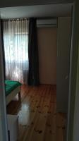 a room with a bed and a window and a wooden floor at Villa Nadija in Čanj