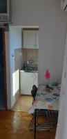 a kitchen with a table with a flower on it at Apartman Lorena in Stari Grad
