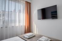 Televízia a/alebo spoločenská miestnosť v ubytovaní Apartament przy Plaży / Klifowa