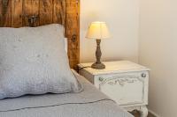 a bedroom with a bed and a lamp on a night stand at Mas Saint Julien in Cavaillon