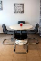 einen Tisch mit vier Stühlen und eine rote Tasse drauf in der Unterkunft studio du botanique in Bayeux