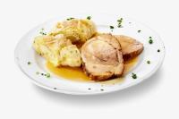 un plato blanco de comida con carne y patatas en Guesthouse Turšič, en Vrhnika