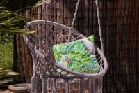 a wicker chair with a pillow on it at Hôtel La Villa Cap d’Antibes in Juan-les-Pins