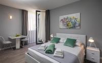 Posteľ alebo postele v izbe v ubytovaní Apartments ZoomZoom