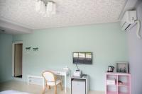 a room with a desk and a chair and a ceiling at Green 58 B&amp;B in Hengchun South Gate