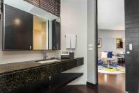 a bathroom with a sink and a mirror at Chatrium Hotel Riverside Bangkok in Bangkok