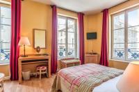 a bedroom with a bed and a desk and windows at Hôtel Du Théâtre Centre Historique Parking Gratuit in Metz