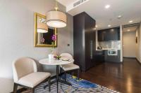 a kitchen and dining room with a table and chairs at Chatrium Hotel Riverside Bangkok in Bangkok