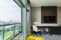 a room with a desk and a view of a city at Chatrium Hotel Riverside Bangkok in Bangkok