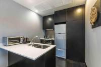 a kitchen with a sink and a refrigerator at Chatrium Hotel Riverside Bangkok in Bangkok