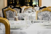 a table with glasses and plates on it at Alexandra Palace - La Maison Younan in Mazières-en-Gâtine