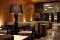 a waiting room with tables and chairs and lamps at Hotel Dùa in Kaohsiung