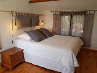 a bedroom with a white bed and a window at Caseddu Di Poggiale in Figari
