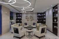 a salon with white chairs and a table and a chandelier at K Hotel Taipei Songjiang in Taipei