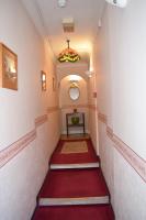 a staircase with a red carpet and a stained glass window at Gatwick Castle B&B in Horley