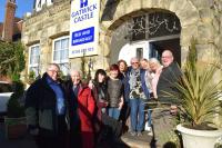 a group of people standing outside of a building at Gatwick Castle B&B in Horley