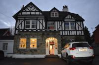 a white car parked in front of a house at Gatwick Castle B&B in Horley