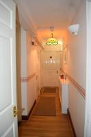 a hallway with a white door and a chandelier at Gatwick Castle B&B in Horley