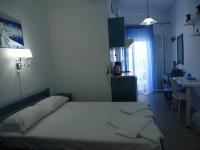 A bed or beds in a room at Kallithea Studios