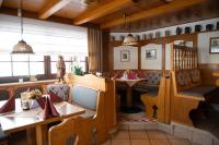 a restaurant with wooden tables and chairs and a dining room at Gasthaus Stroh in Buchholz
