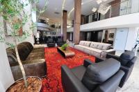 a large living room with couches and a tree at Klein Ville São Leopoldo in São Leopoldo