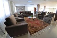a waiting room with couches and chairs and a table at Klein Ville São Leopoldo in São Leopoldo