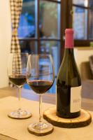 a bottle of wine and two glasses on a table at Gorska bajka - Smreka, kuća za odmor i wellness in Stara Sušica