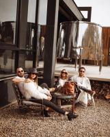 a group of people sitting in chairs in front of a building at Encuentro Guadalupe in Valle de Guadalupe