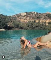 a woman laying in the water in a pool at Encuentro Guadalupe in Valle de Guadalupe