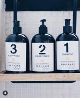 three bottles of detergent sitting on a shelf at Encuentro Guadalupe in Valle de Guadalupe