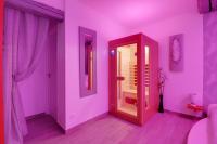 a purple room with a mirror and a door at Suite Cupidon- Domaine des trois châteaux in Moisenay