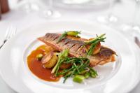 een bord met eten met vlees en groenten op een tafel bij Burnham Beeches Hotel & Spa in Windsor