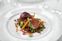 een bord met eten met vlees en groenten op een tafel bij Burnham Beeches Hotel & Spa in Windsor