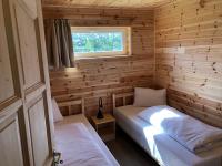 A bed or beds in a room at Napsugár Club és Panzió