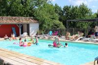 a group of people playing in a swimming pool at Le Vignal in Monflanquin