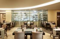 a dining room with tables and chairs in a restaurant at Seoul Riviera Hotel in Seoul