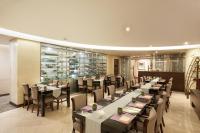 a restaurant with tables and chairs in a room at Seoul Riviera Hotel in Seoul